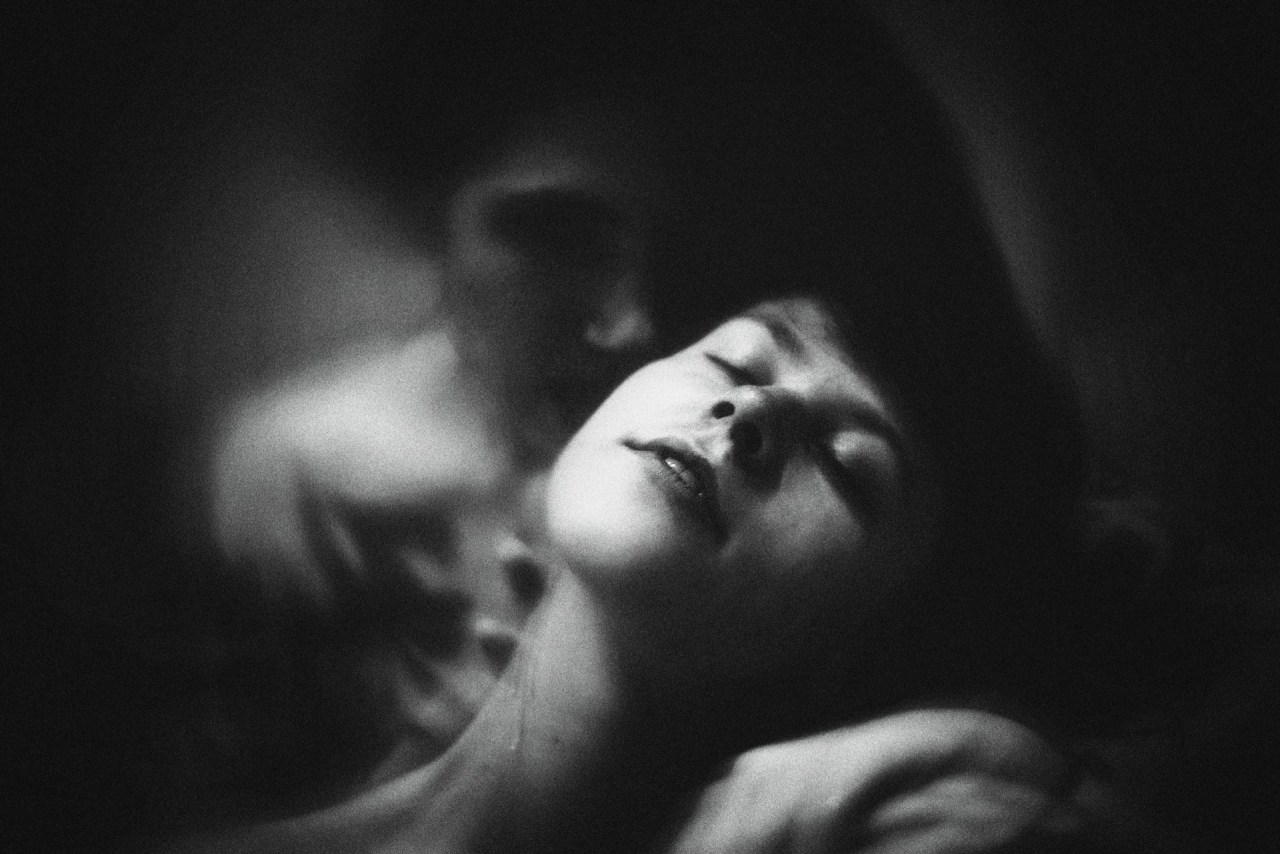 Woman looking upward in a reflective moment, representing the emotional difference between being needed and being loved.
