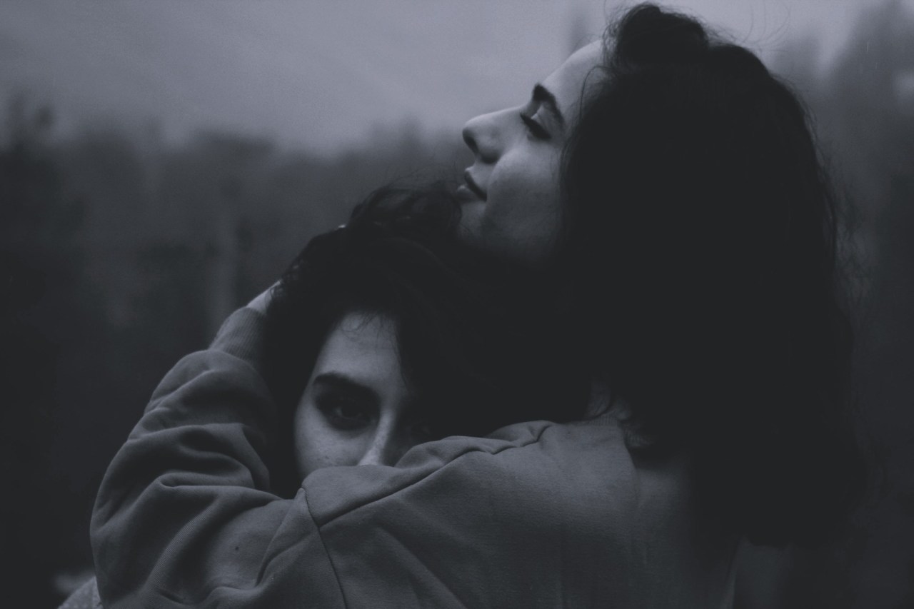 Black and white image of a woman lying awake in bed, reflecting on the difference between someone’s promises and their repeated behavior.